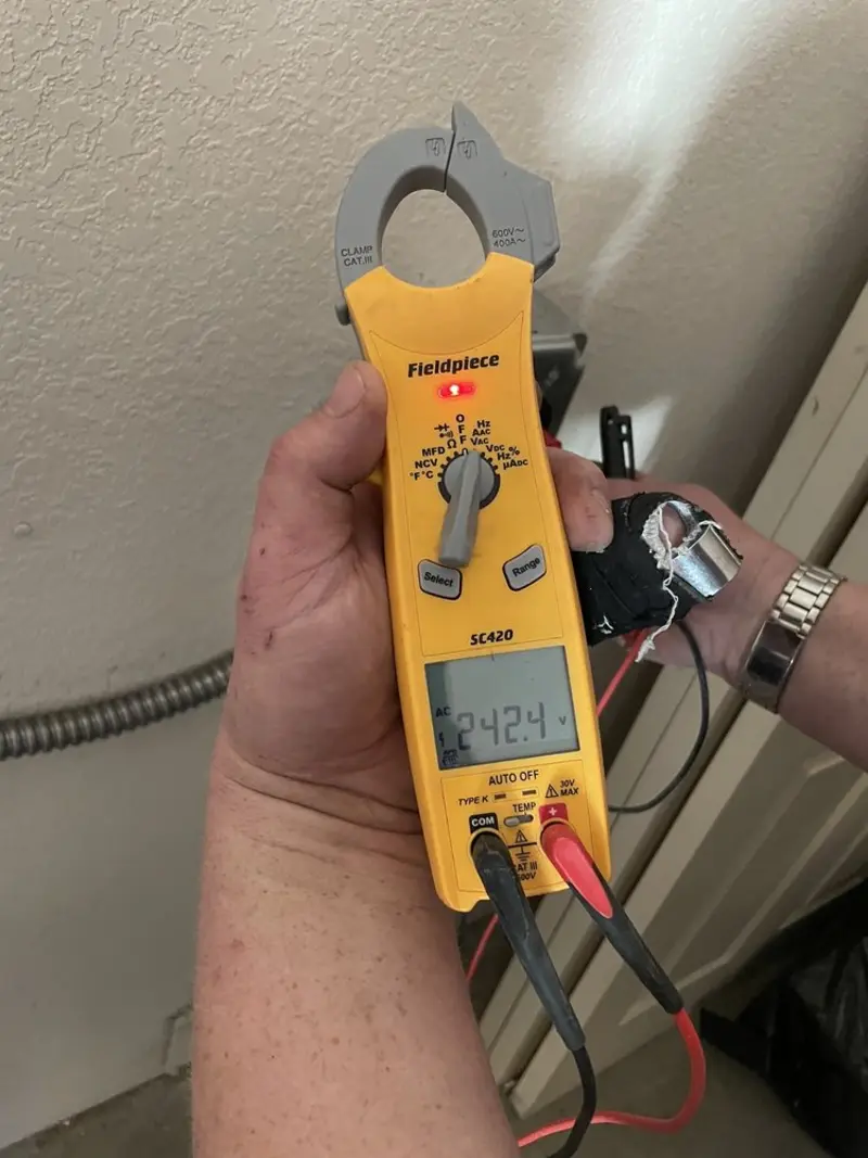 Voltage testing with clamp meter during Recessed Lighting Installation in Eden Isle
